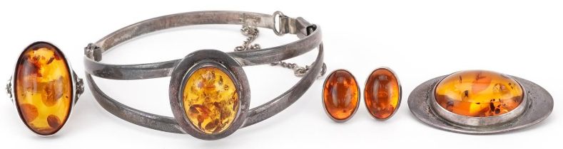 Silver natural amber jewellery comprising hinged bangle, brooch, ring and earrings, the bangle 6.5cm