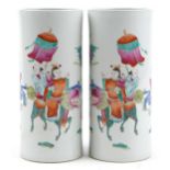 Pair of Chinese porcelain cylindrical vases hand painted in the famille rose palette with a family