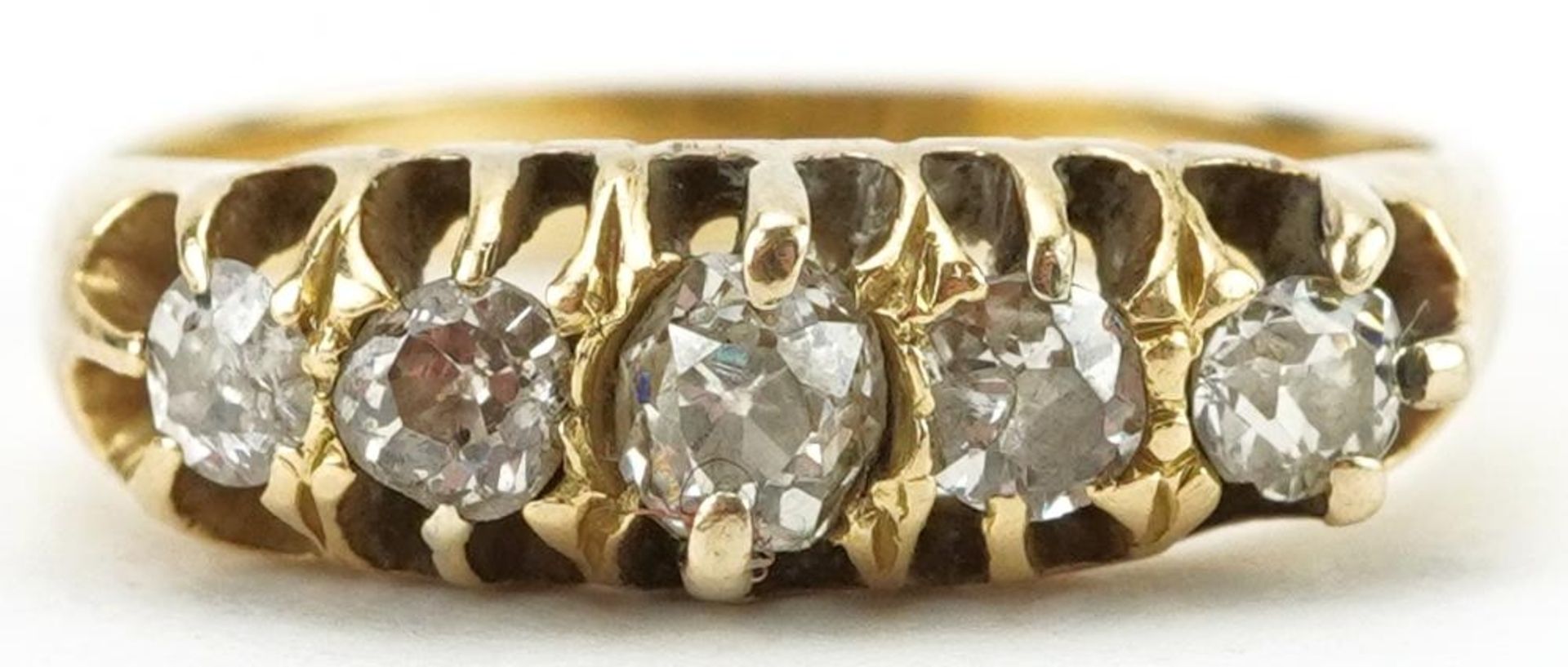 Unmarked gold graduated diamond five stone ring, total diamond weight approximately 0.25 carat, size