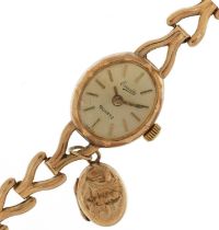 Everite, ladies 9ct gold wristwatch with 9ct gold strap and an unmarked gold locket, the case 15mm
