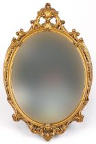 Ornate gilt framed oval wall mirror decorated with acanthus leaves, 72cm x 47cm
