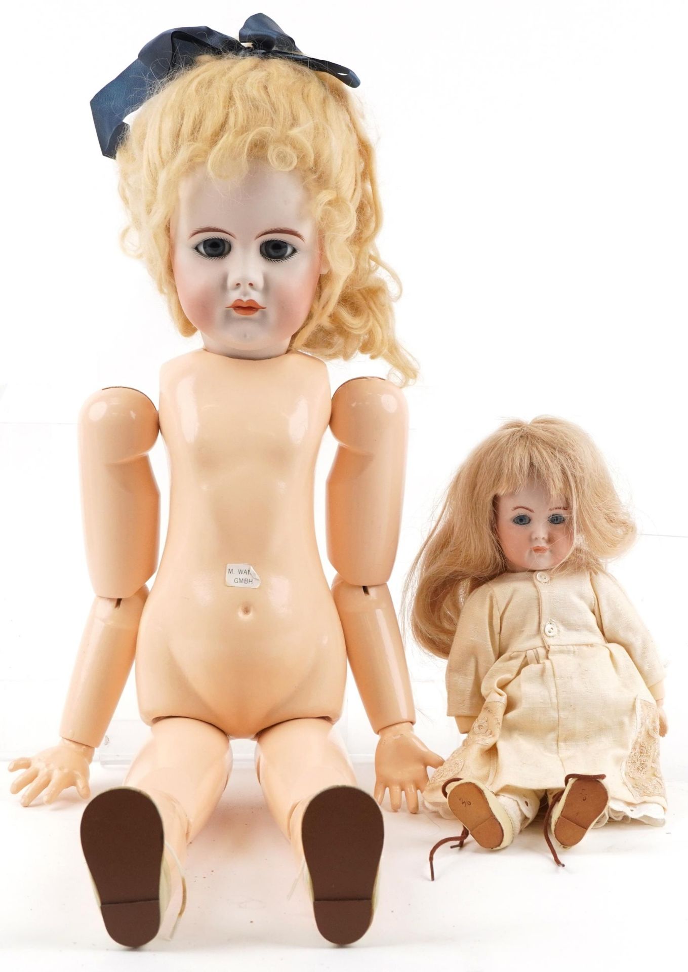 Two bisque headed dolls with jointed limbs including a Simon Halbig example, the largest 66cm high