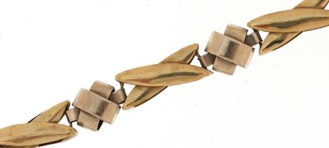 Modernist broken two tone 9ct gold crossover bracelet, 19cm in length, 9.9g
