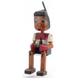 Hand painted carved wood figure of Pinocchio with jointed arms and legs, 35cm high