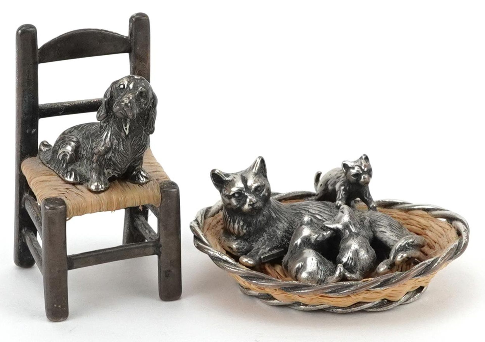 Two miniature silver and wicker animals comprising cat in a basket with kittens and a dog seated