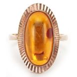 Modernist 9ct gold cabochon natural amber ring with engine turned setting, size P, 4.8g