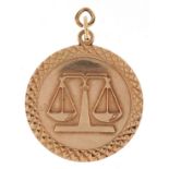 9ct gold masonic interest pendant in the form of mason's scales, 2.4cm in diameter, 4.8g