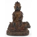 Chino Tibetan gilt bronze figure of Buddha on mythical animal, 22.5cm high