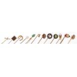 Twelve antique and later gold and yellow metal stickpins including ruby and diamond, opal and