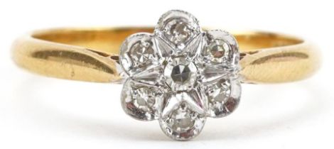 18ct gold diamond flower head ring, the central diamond approximately 2.20mm in diameter, size M,