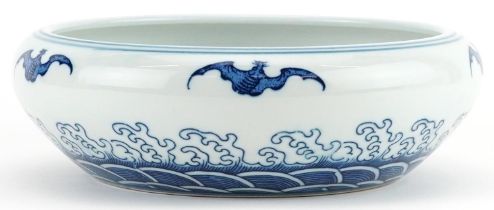 Chinese blue and white porcelain bowl decorated with bats above crashing waves, six figure character