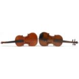 Two wooden violins with green baize lined wooden cases, the violin back 14 inches in length