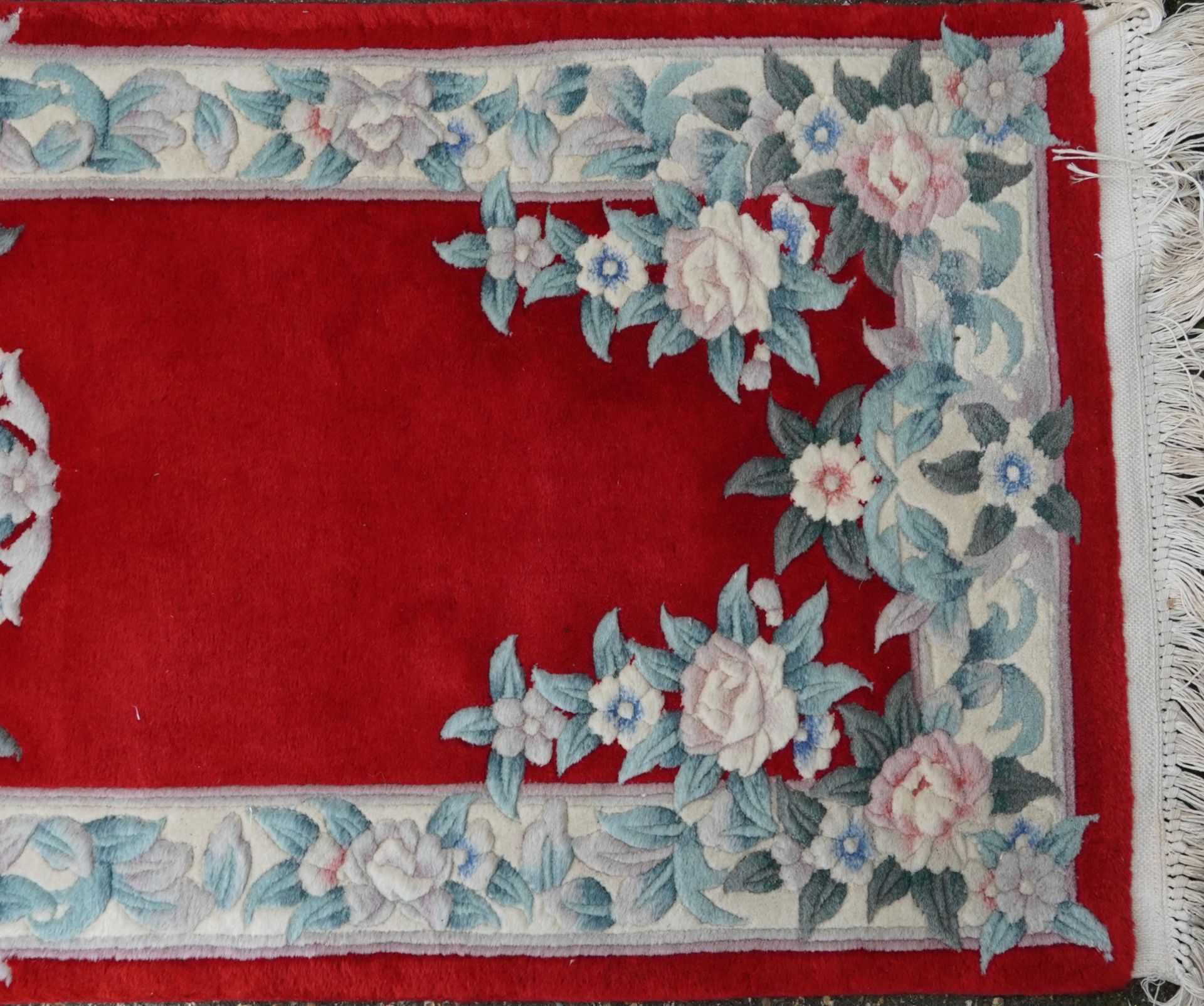 Three Chinese red ground floral rugs including a runner, the largest 255cm x 70cm - Image 13 of 13
