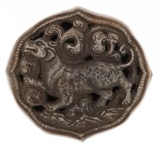 Indo Persian white metal buckle cast and pierced with a mythical animal amongst clouds, 8.5cm wide