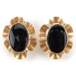 Pair of 9ct gold black onyx flower head stud earrings, each 9mm high, total 0.7g