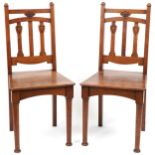 Pair of Arts & Crafts oak side chairs carved with hearts, 96cm high