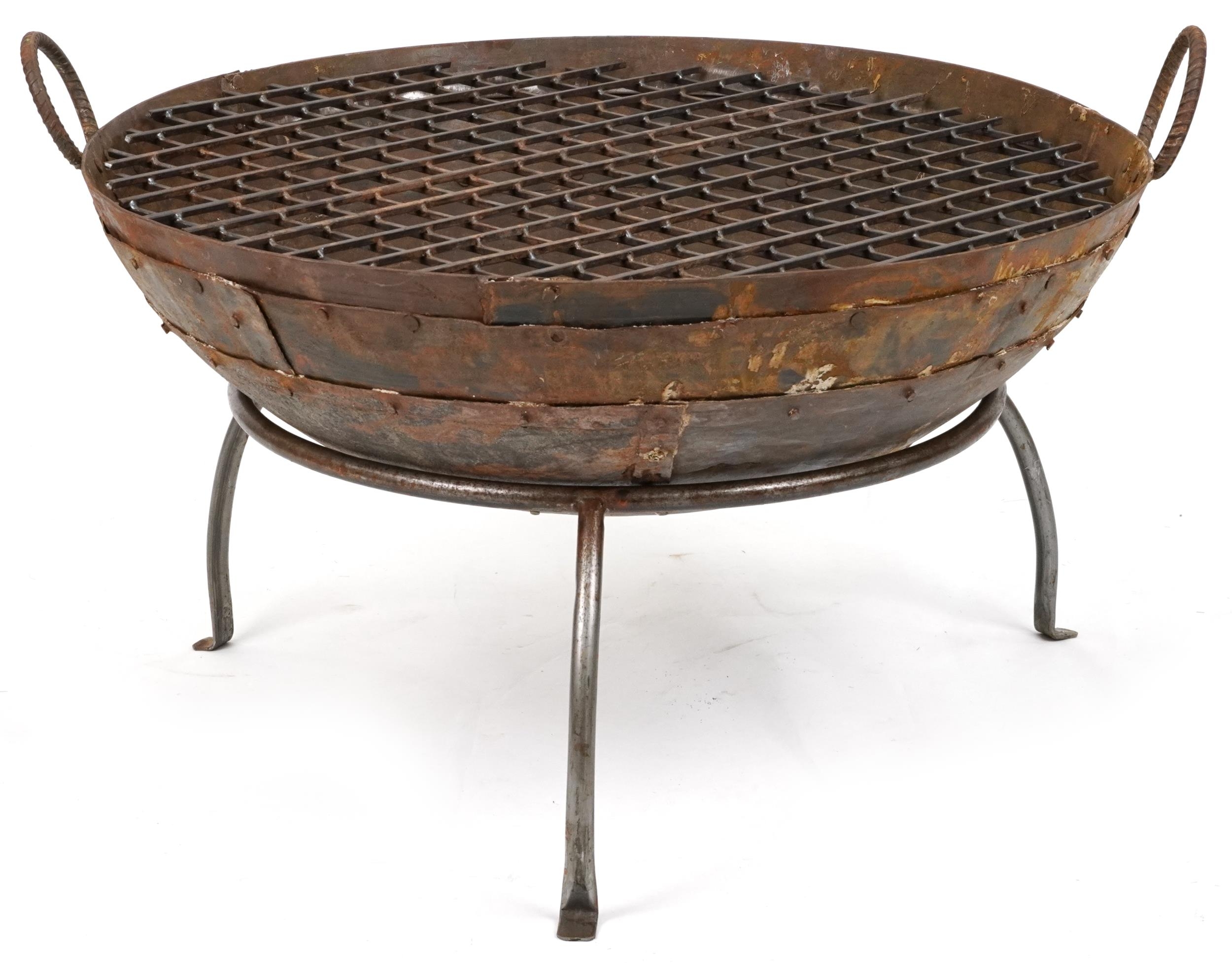 Cast metal firepit with twin handles and grill on tripod stand, 50cm high x 90.5cm in diameter