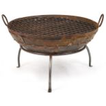 Cast metal firepit with twin handles and grill on tripod stand, 50cm high x 90.5cm in diameter