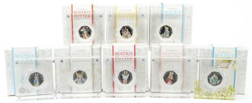 Eight Beatrix Potter silver proof fifty pence pieces by The Royal Mint, housed in Perspex slabs with