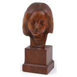 Continental carved fruitwood bust of a young female raised on a square block base, indistinctly