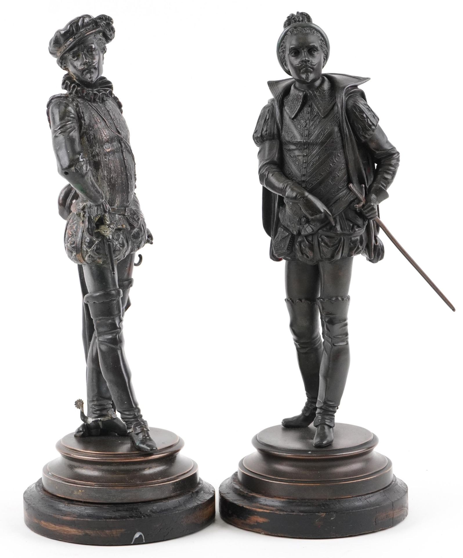 Pair of Victorian patinated spelter figures in 17th century dress raised on circular ebonised wooden