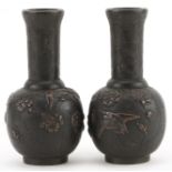 Pair of Japanese bronze vases cast in relief with birds of paradise amongst flowers, each 12cm high