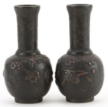 Pair of Japanese bronze vases cast in relief with birds of paradise amongst flowers, each 12cm high