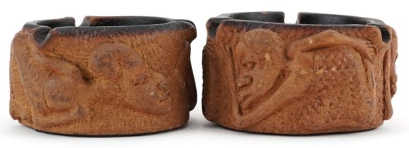 Matched pair of smoking interest Meerschaum ashtrays decorated in relief with figures, each 10cm