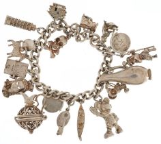 Silver charm bracelet with a collection of mostly silver charms including Mickey Mouse, Leaning