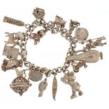 Silver charm bracelet with a collection of mostly silver charms including Mickey Mouse, Leaning