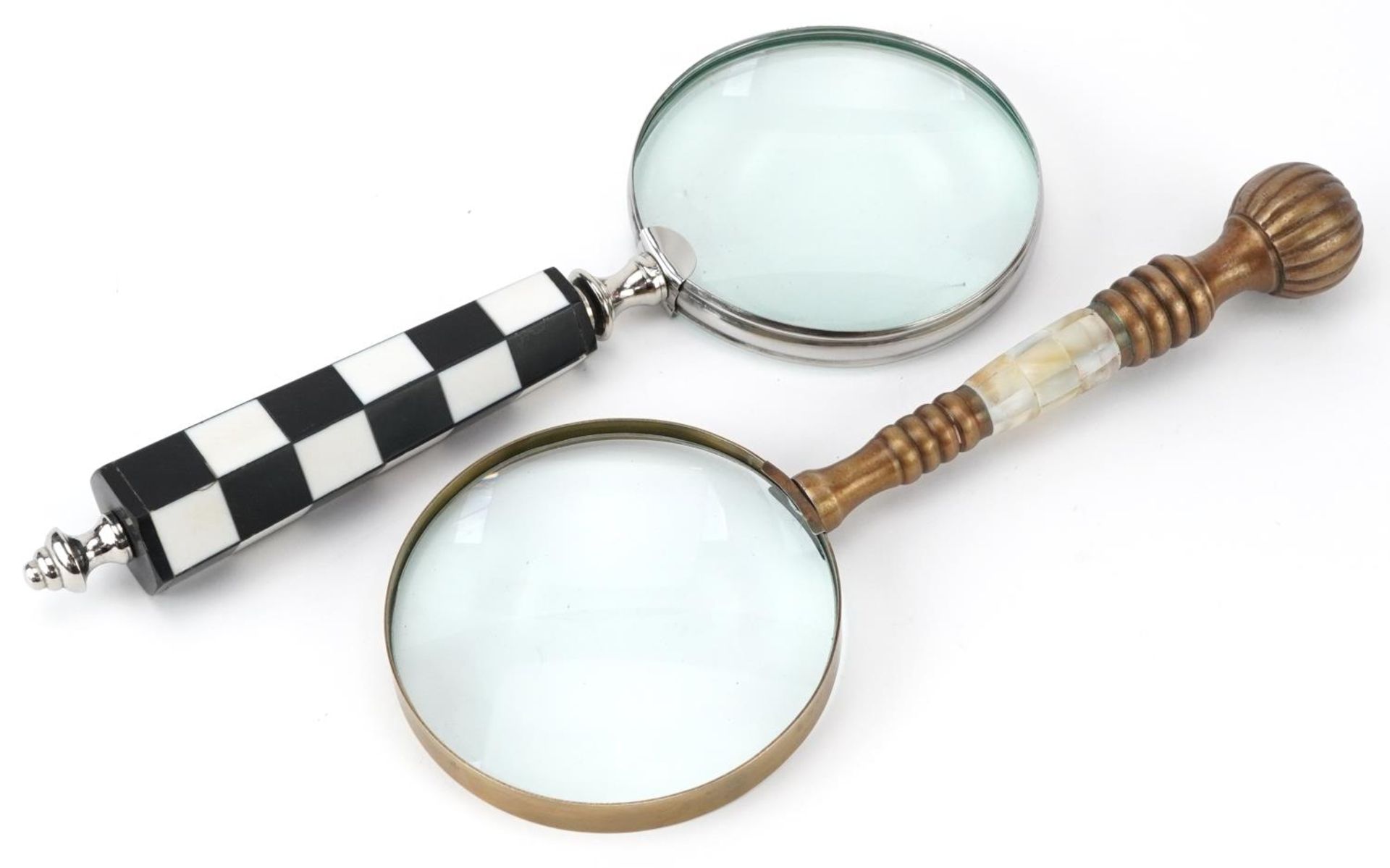 Two magnifying glasses including an example with chequered design handle, the largest 26cm in length