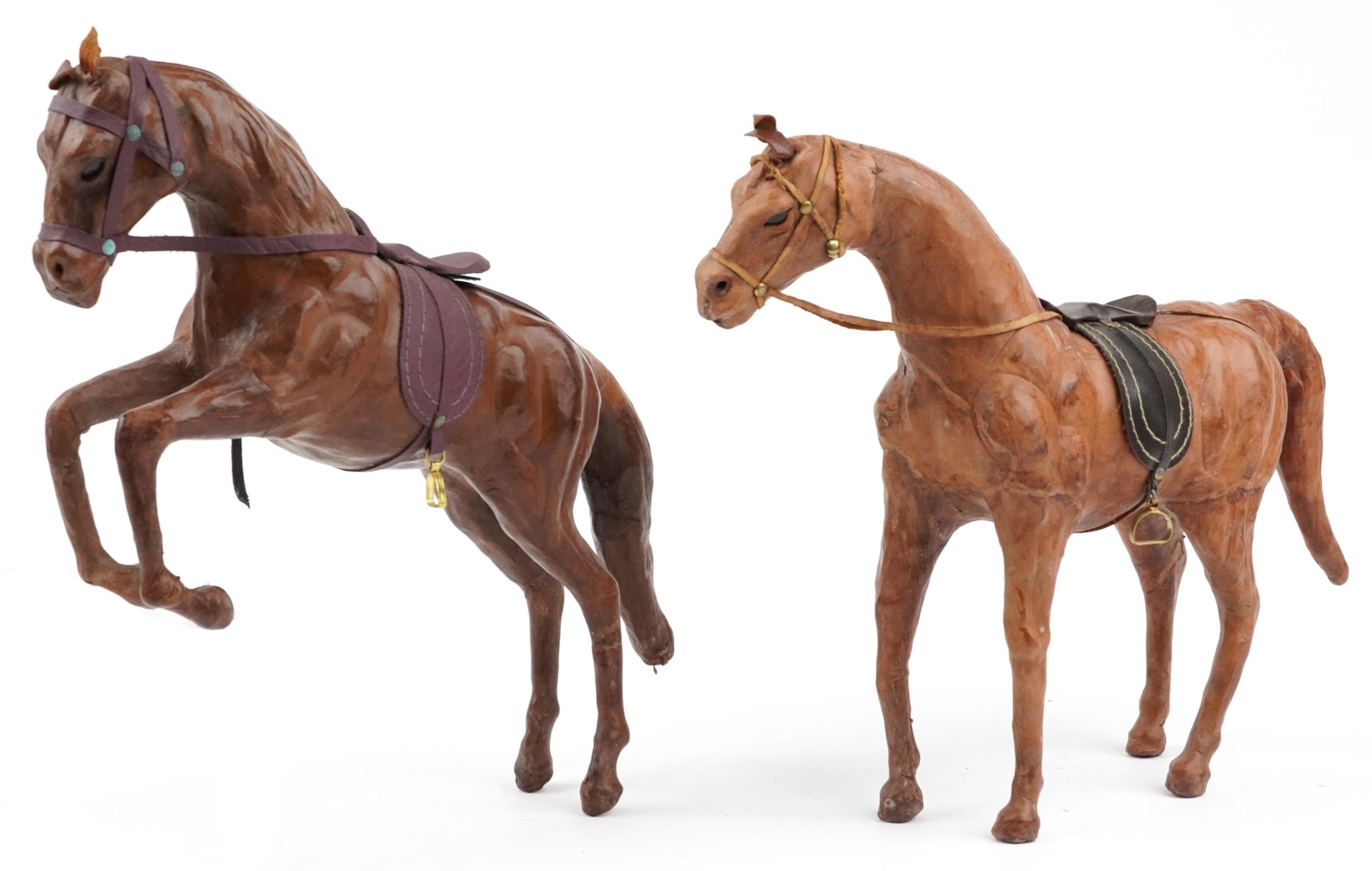 Manner of Liberty & Co, two leather covered horses including a rearing example, 40cm high