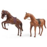 Manner of Liberty & Co, two leather covered horses including a rearing example, 40cm high