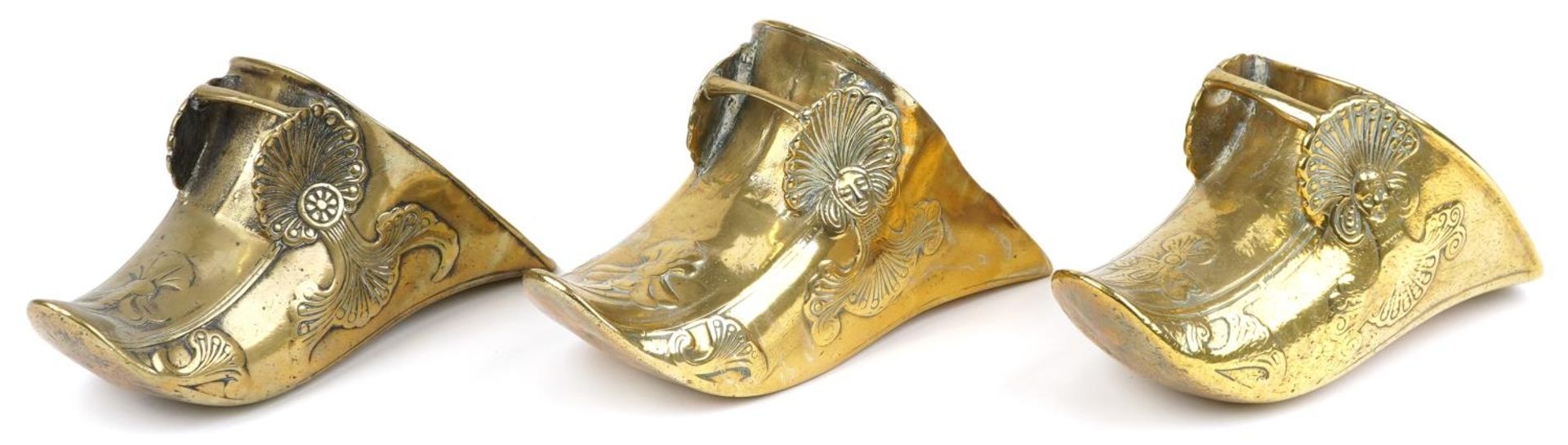 Three 19th century Spanish Conquistador brass stirrups with foliate decoration including a pair,