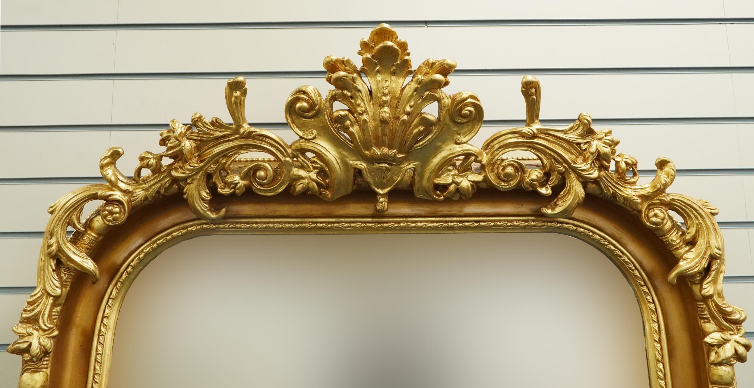 Large ornate gilt framed wall mirror having bevelled glass mounted with flowers and foliage, 220cm x - Image 2 of 4