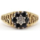18ct gold diamond and sapphire flower head ring with pierced bark design shoulders, size M, 4.2g