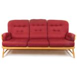 Ercol light elm Jubilee stick back three seater settee with red fleur de lis upholstered cushioned