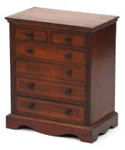 Early 20th century inlaid mahogany apprentice chest fitted with an arrangement of six drawers,