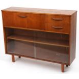 Avalon, mid century teak side cabinet fitted with a fall and two drawers above a pair of glass