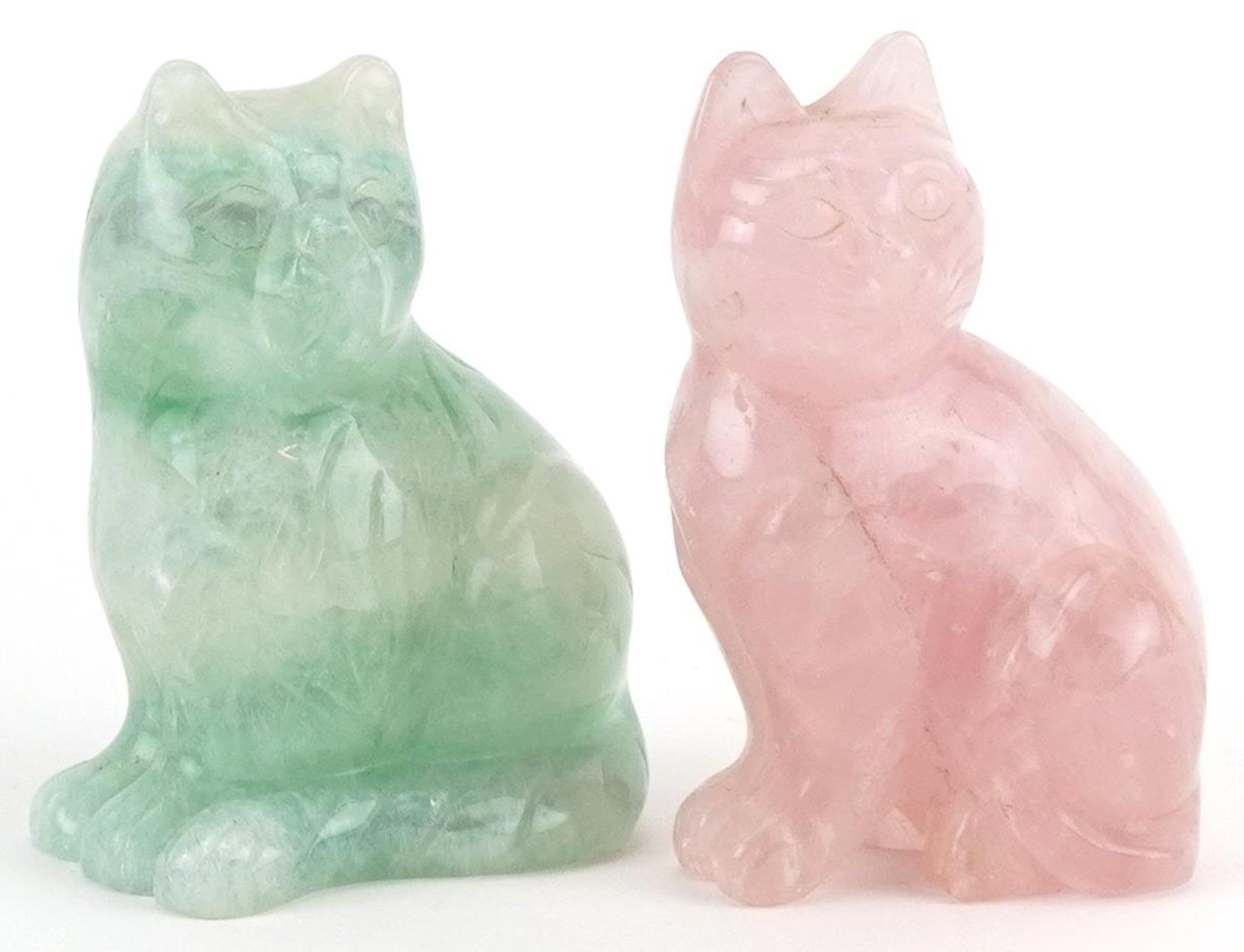 Two carved hardstone cats comprising rose quartz and fluorite, the largest 8.5cm high
