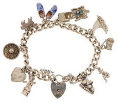 Silver charm bracelet with love heart padlock and a collection of mostly silver charms including a