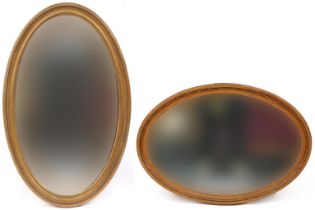 Two oval gilt framed wall mirrors with bevelled glass, the largest 93cm x 58cm