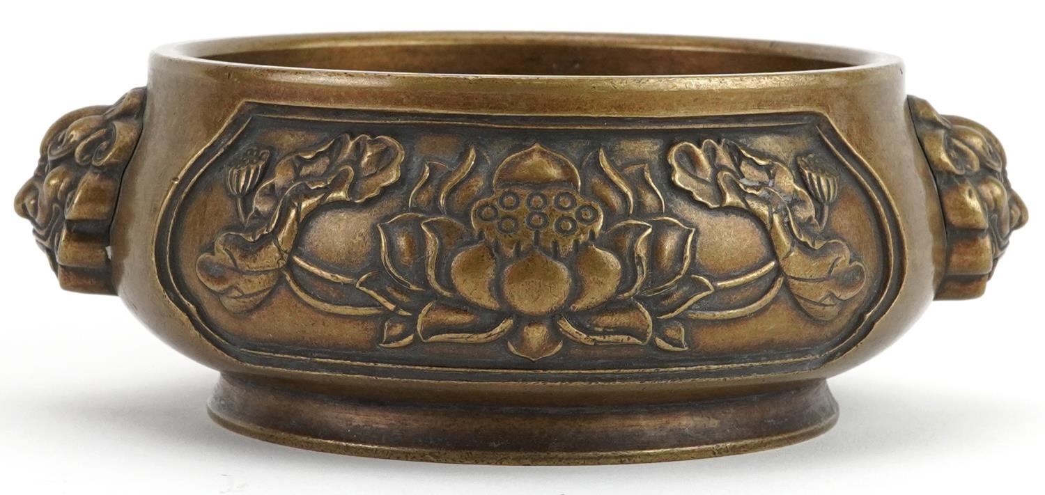 Chinese patinated bronze censer with animalia handles cast in relief with panels of flowers, four