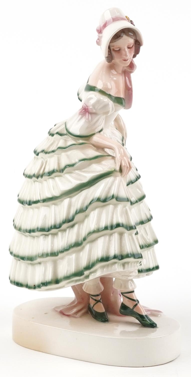 Keramos, Austrian Art Deco figurine of a female wearing a green brimmed dress, 31cm high