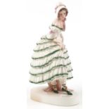 Keramos, Austrian Art Deco figurine of a female wearing a green brimmed dress, 31cm high