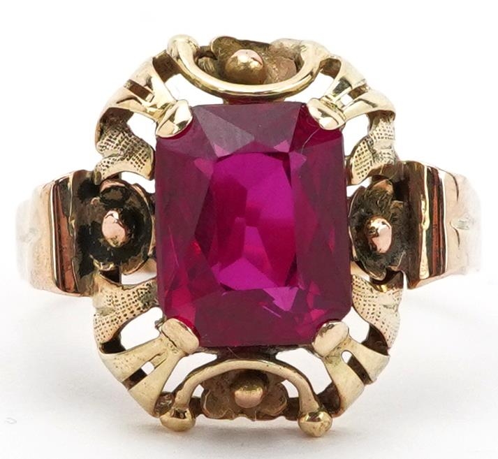 Continental unmarked gold ruby ring with pierced flower head setting, tests as 15ct gold, the ruby
