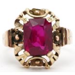 Continental unmarked gold ruby ring with pierced flower head setting, tests as 15ct gold, the ruby