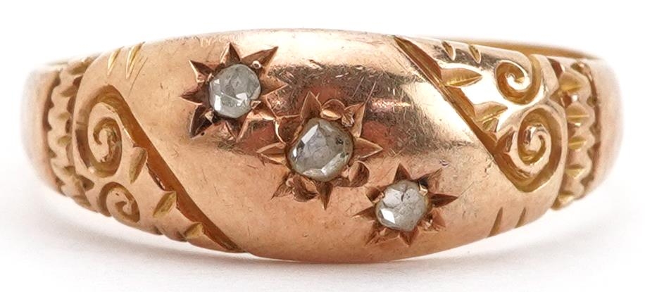 Victorian 18ct gold diamond three stone ring with engraved scrolled shoulders, indistinct
