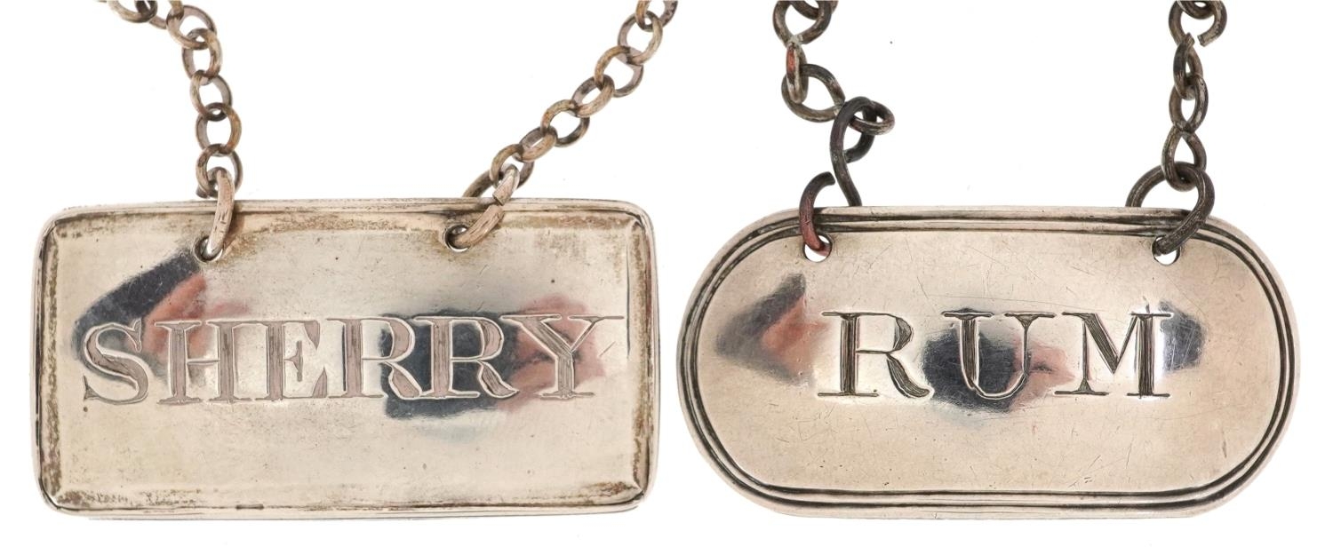 Two George III silver decanter labels comprising sherry and rum, 1800 and 1814, each 4.4cm wide,