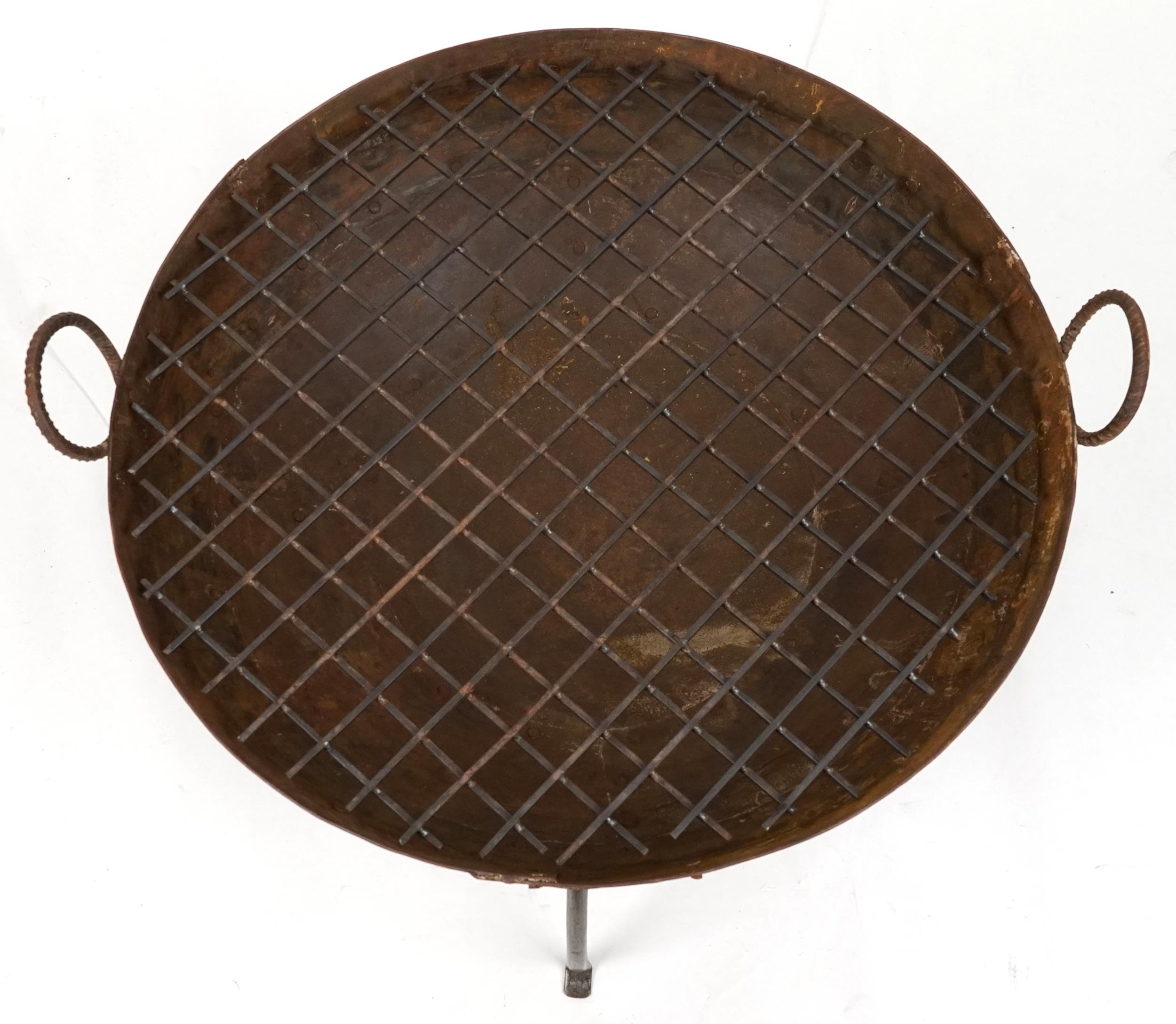 Cast metal firepit with twin handles and grill on tripod stand, 50cm high x 90.5cm in diameter - Image 2 of 3